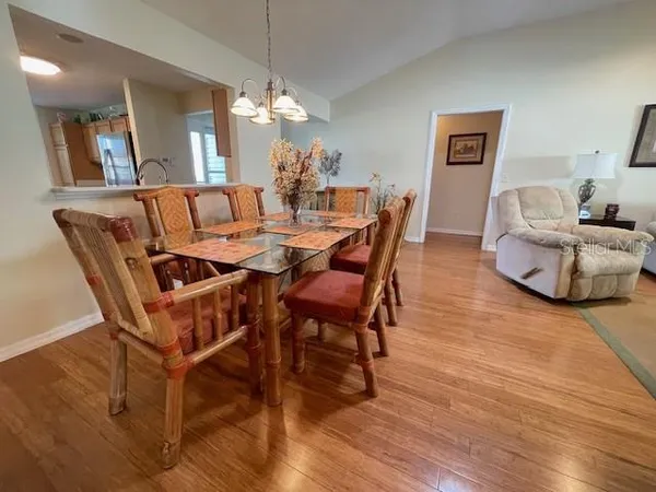 a dining room with furniture and wooden floor