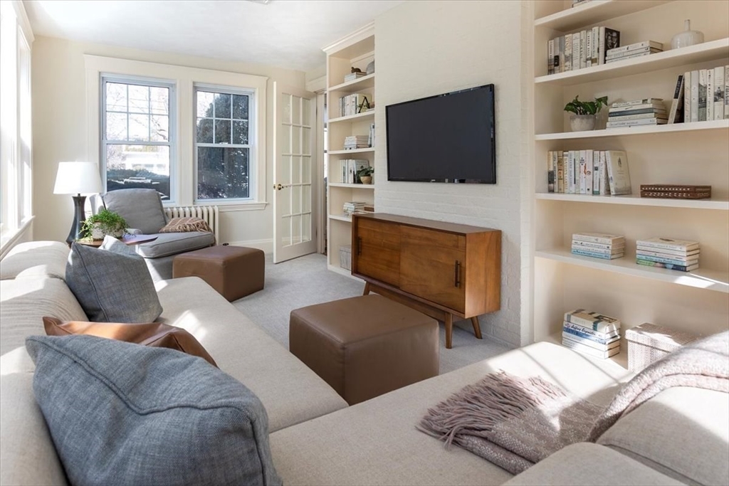 50 Halcyon Road Newton, MA 02459 - Photo 6 of 26 a living room with furniture a flat screen tv and a fireplace