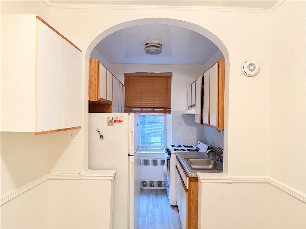1900 Quentin Road, Unit A15 Brooklyn, NY 11229 - Photo 5 of 8 a kitchen with a stove a refrigerator and a stove