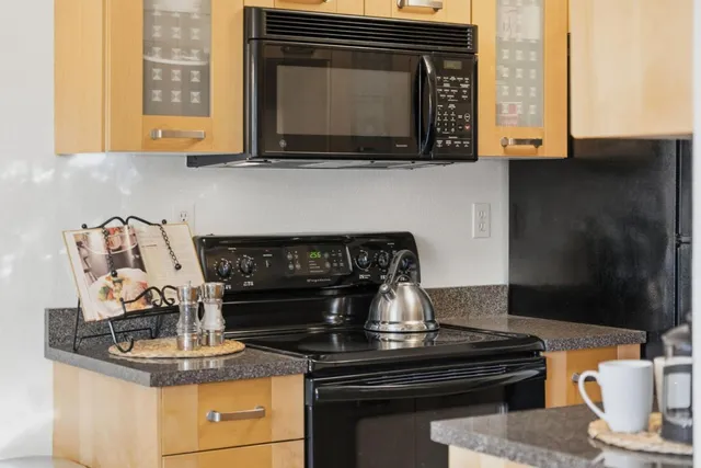 a stove top oven sitting inside of a kitchen