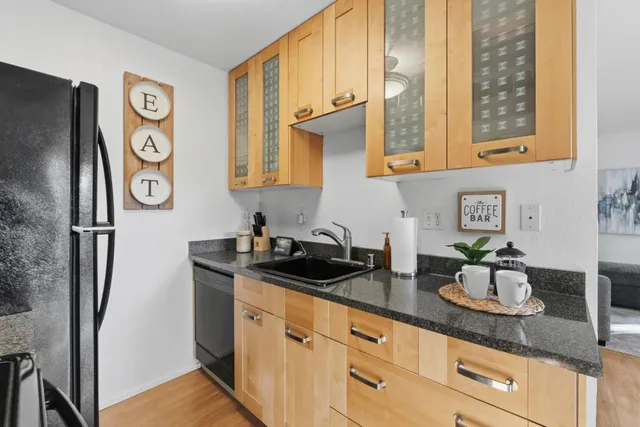a kitchen with stainless steel appliances granite countertop a sink and a granite counter tops