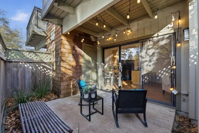 a view of a porch with a table and chairs