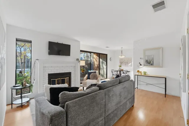 a living room with furniture a fireplace and a flat screen tv