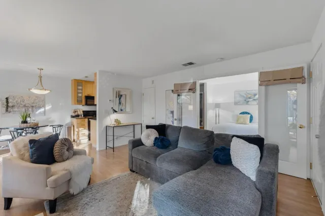 a living room with furniture and wooden floor