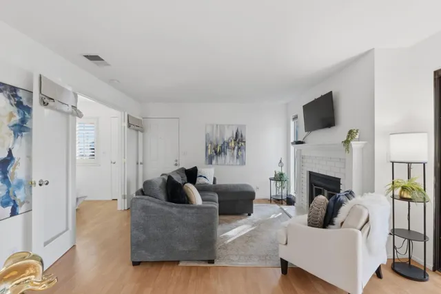 a living room with furniture a fireplace and a flat screen tv