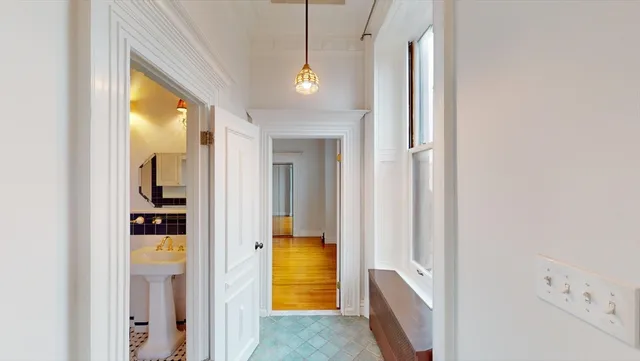 a view of a hallway view with wooden floor and living room