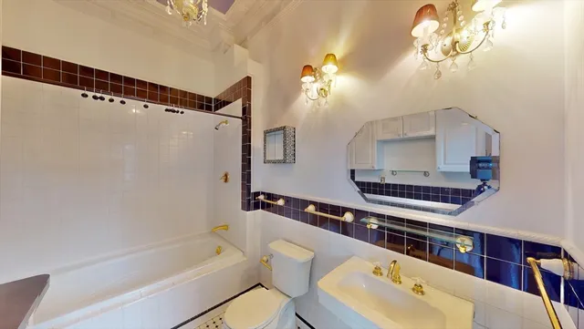 a bathroom with a tub a sink and a mirror