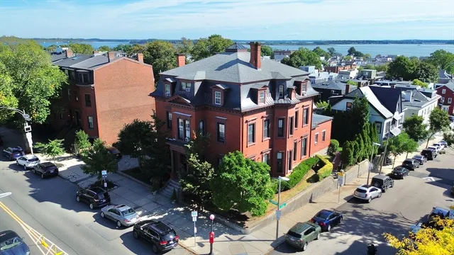a aerial view of a multi story building with yard
