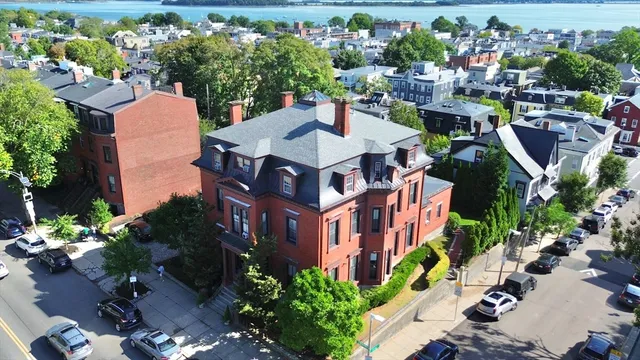 an aerial view of a house with a yard patio and lake view