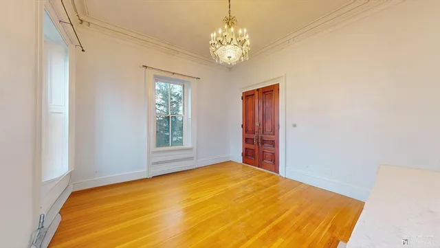 a bedroom with a bed and a chandelier