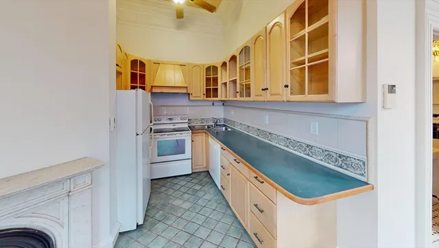 a kitchen with granite countertop a sink and a stove top oven