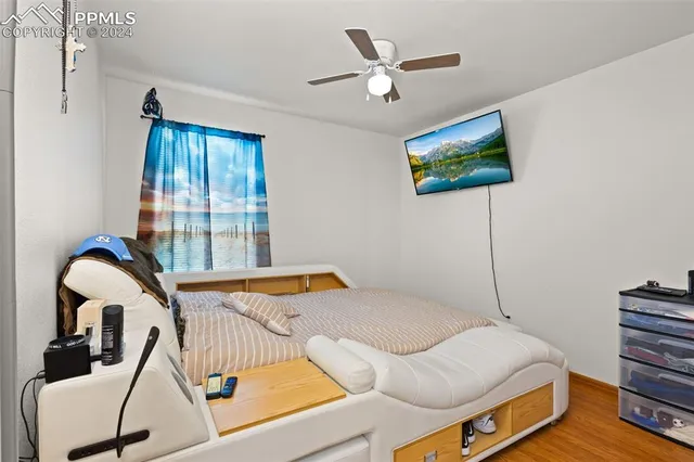 a bedroom with a bed and a painting on the wall