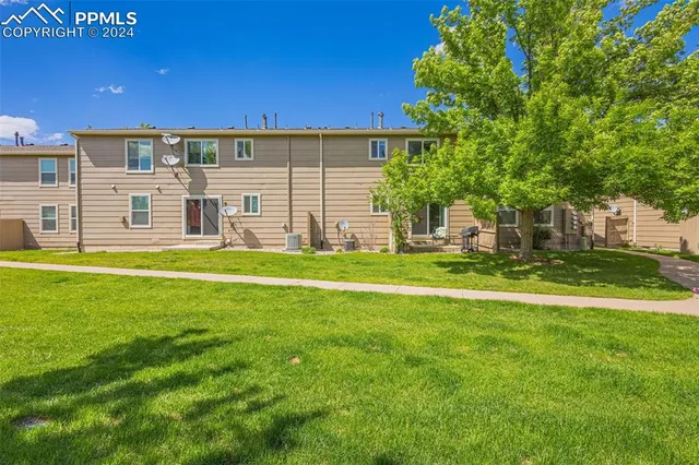 a house view with swimming pool in front of it
