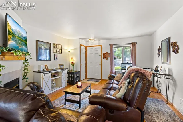 a living room with furniture a couch and a flat screen tv