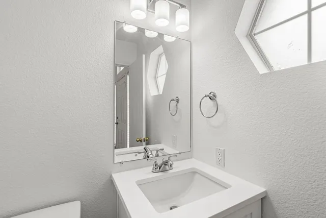 a bathroom with a sink vanity and a mirror