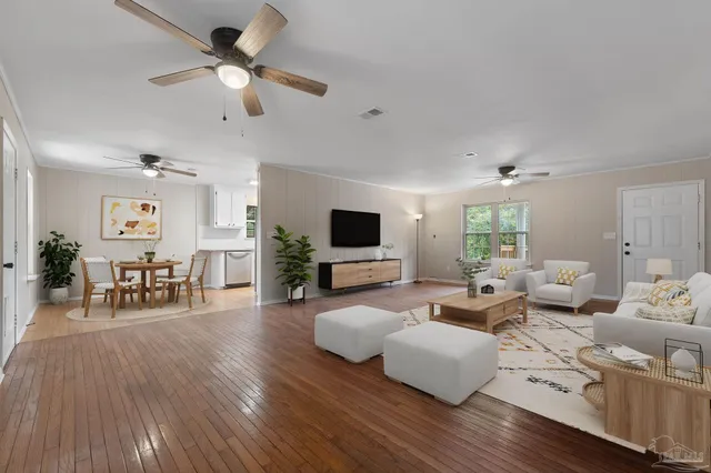 a living room with furniture and a flat screen tv