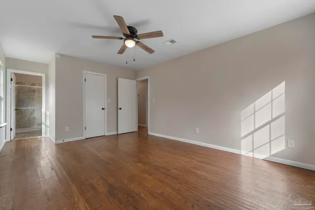 a view of an empty room and wooden floor