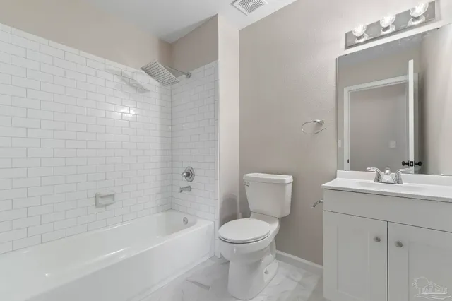 a bathroom with a toilet a sink a mirror and bathtub