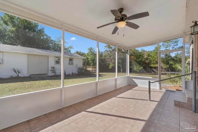 a view of a porch with furniture and garden