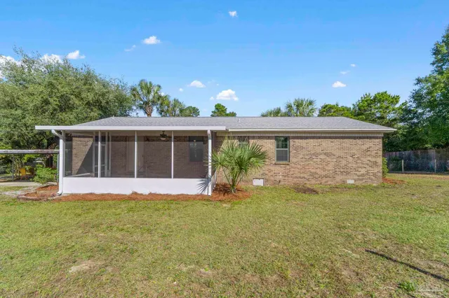 a front view of a house with a garden and yard