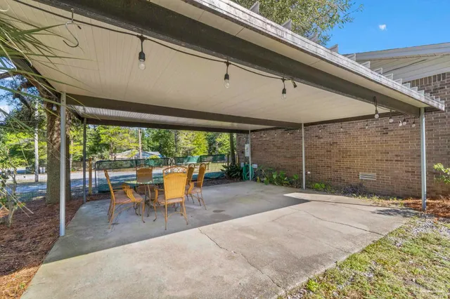 a view of a patio with table and chairs potted plants with wooden floor