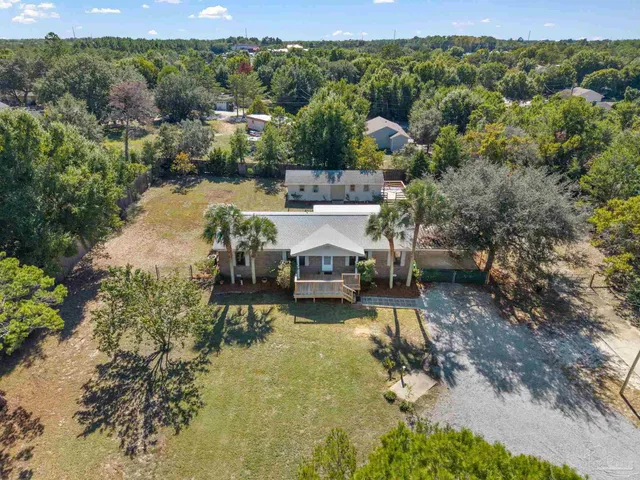an aerial view of a house with a lake view