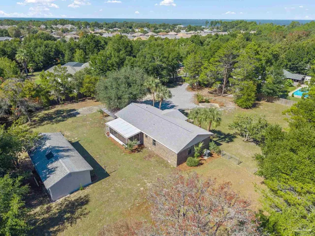an aerial view of a house with a yard