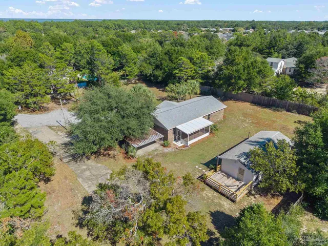 an aerial view of a house with a yard