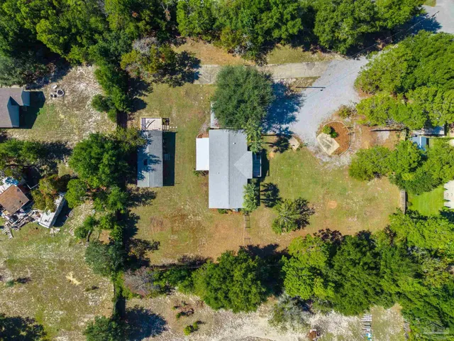 an aerial view of a house with a yard