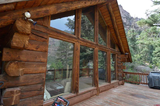 a view of a roof deck with wooden fence and plants