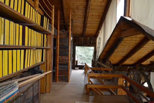 a view of front door and bedroom with furniture