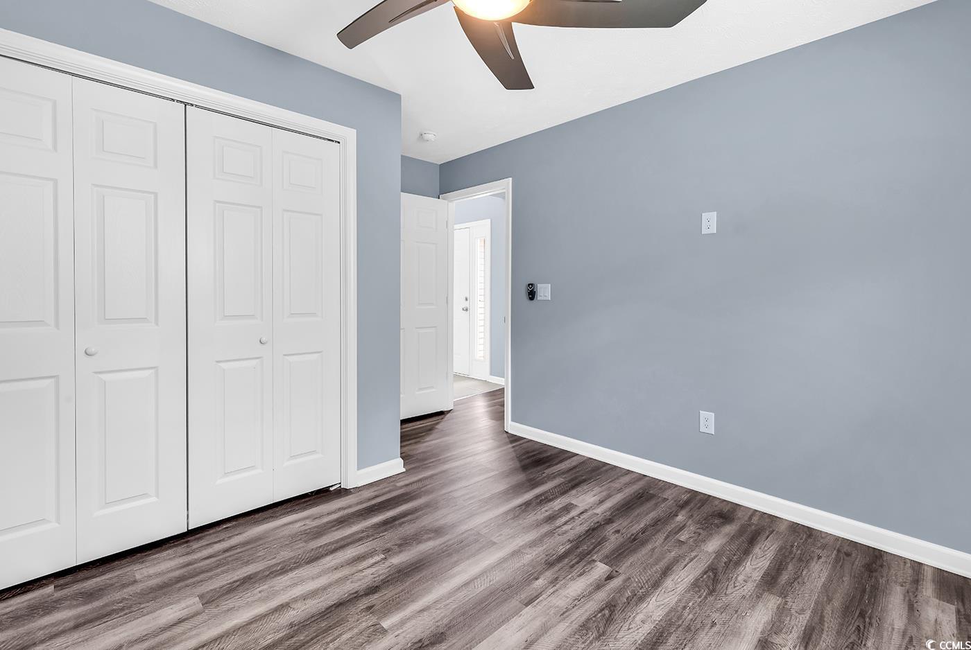 389 Barton Loop Myrtle Beach, SC 29579 - Photo 11 of 40 Unfurnished bedroom with a closet, dark wood-style