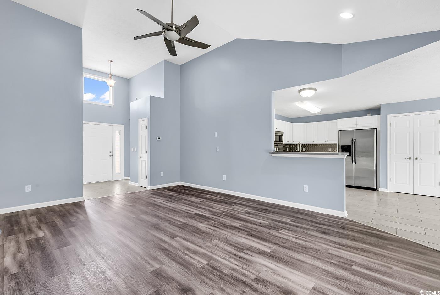 389 Barton Loop Myrtle Beach, SC 29579 - Photo 13 of 40 Unfurnished living room with ceiling fan, high vau