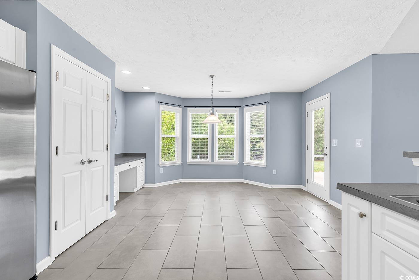 389 Barton Loop Myrtle Beach, SC 29579 - Photo 15 of 40 Unfurnished dining area with tile patterned floors