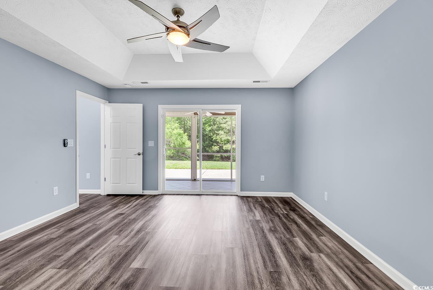 389 Barton Loop Myrtle Beach, SC 29579 - Photo 22 of 40 Empty room with baseboards, ceiling fan, dark wood