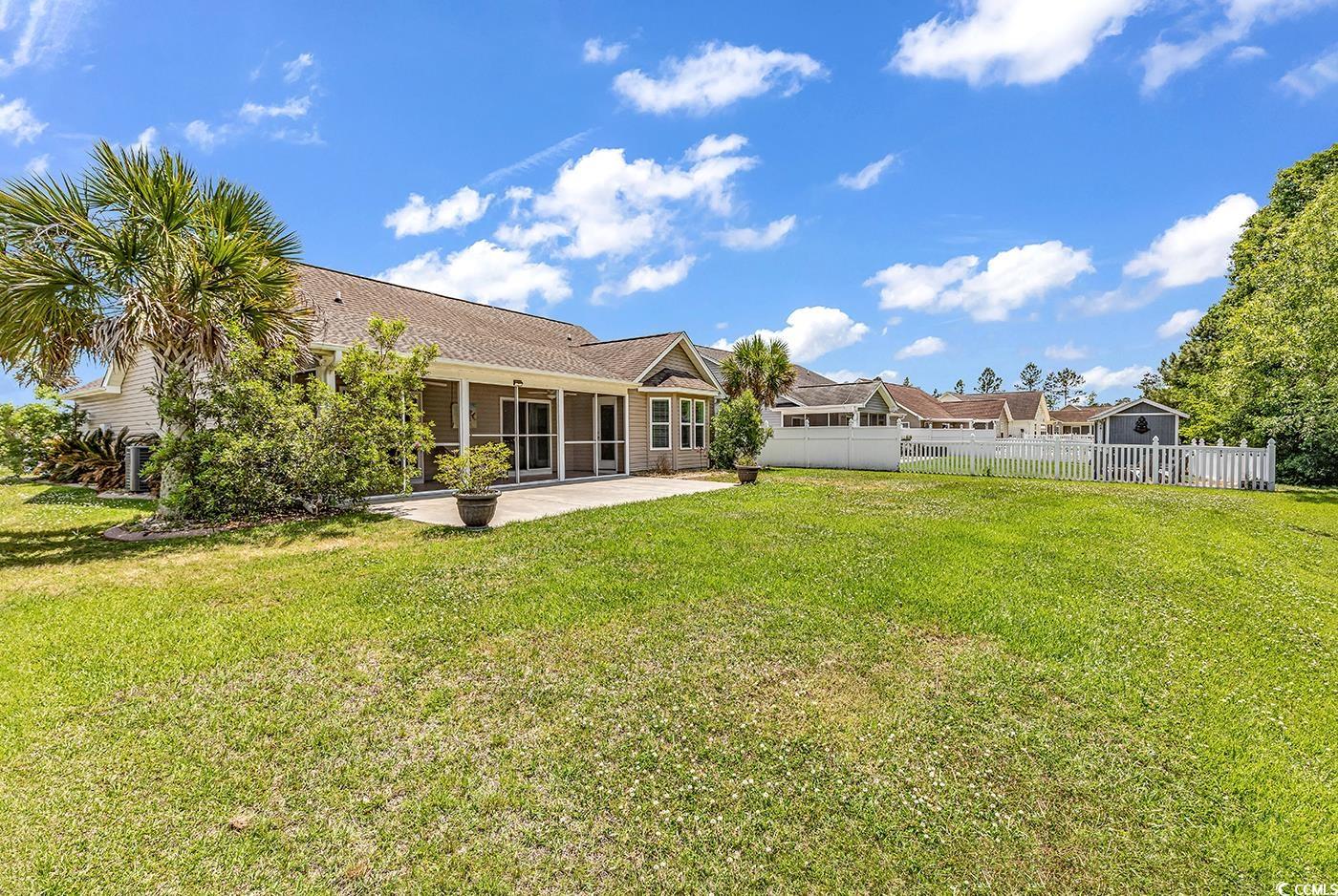 389 Barton Loop Myrtle Beach, SC 29579 - Photo 37 of 40 View of yard featuring a sunroom, fence, and a pat