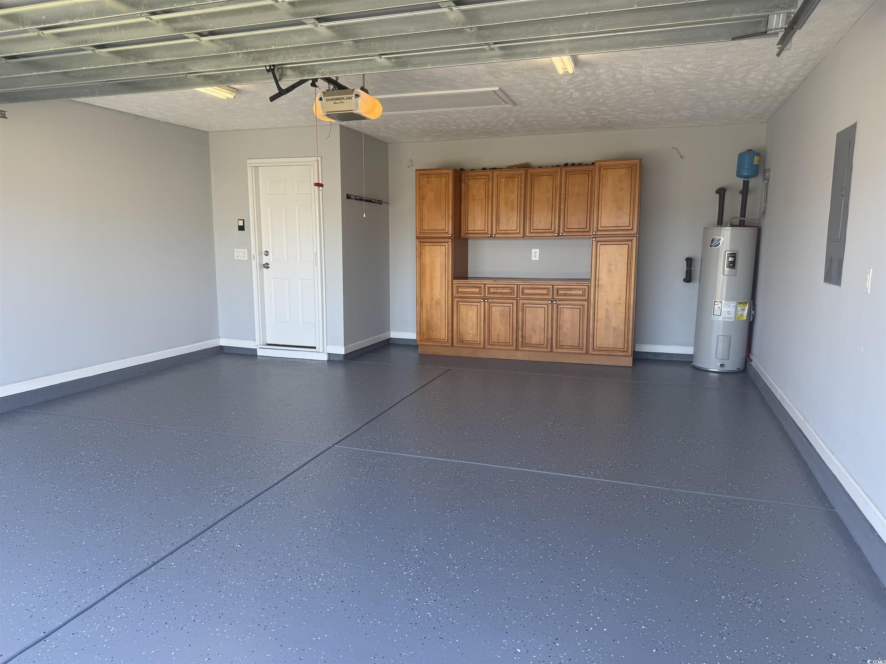 389 Barton Loop Myrtle Beach, SC 29579 - Photo 40 of 40 Garage with baseboards, a garage door opener, wate
