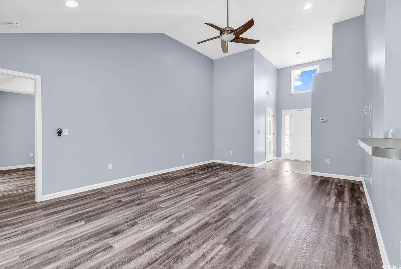 389 Barton Loop Myrtle Beach, SC 29579 - Photo 6 of 40 Unfurnished living room with ceiling fan, high vau