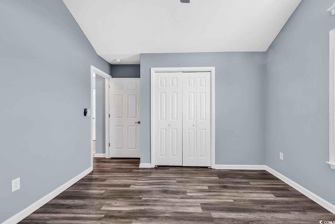 389 Barton Loop Myrtle Beach, SC 29579 - Photo 8 of 40 Unfurnished bedroom featuring baseboards, dark woo