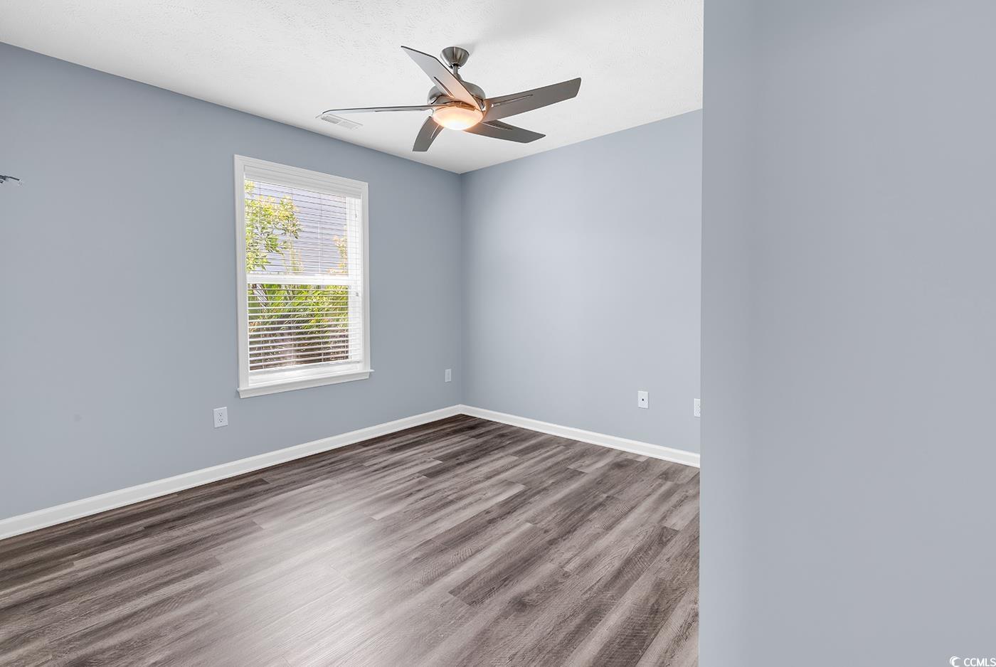 389 Barton Loop Myrtle Beach, SC 29579 - Photo 10 of 40 Empty room featuring baseboards, a ceiling fan, an