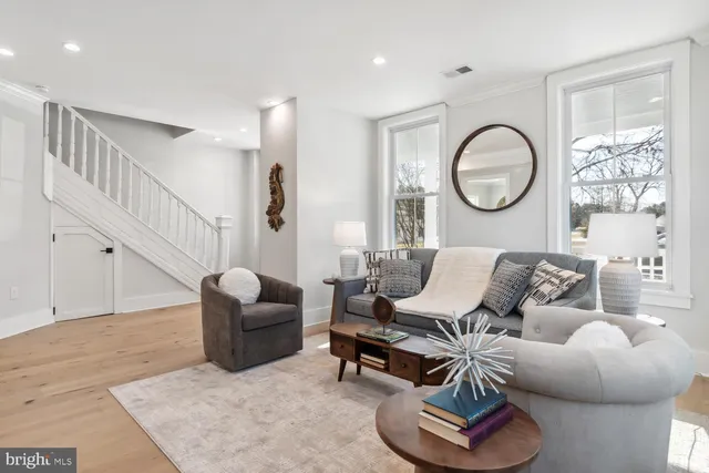 a living room with furniture or couch and a wooden floor