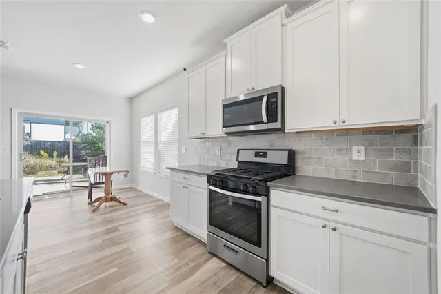 a large kitchen with a table and chairs