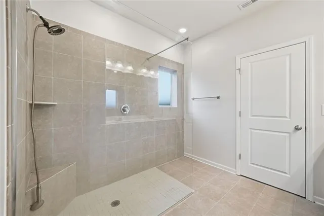 an empty room with a window and a ceiling fan