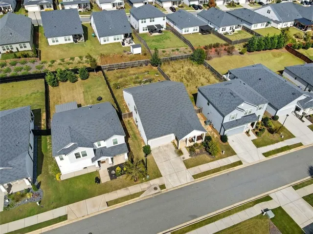 an aerial view of residential houses with outdoor space