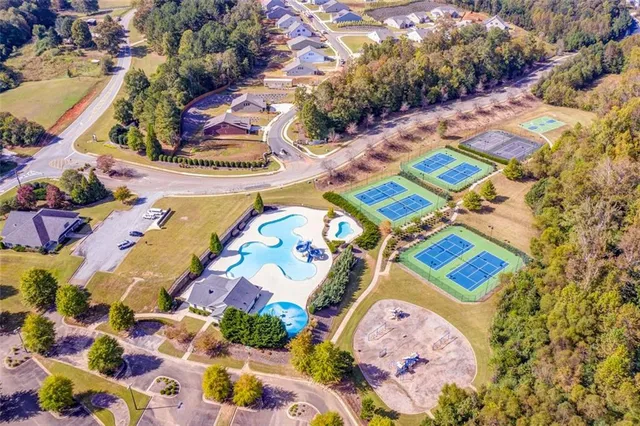 an aerial view of a house with swimming pool garden and patio