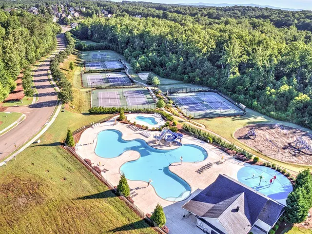 an aerial view of a house with yard swimming pool and mountain view