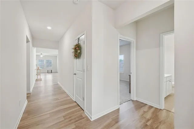 a view of a hallway with wooden floor