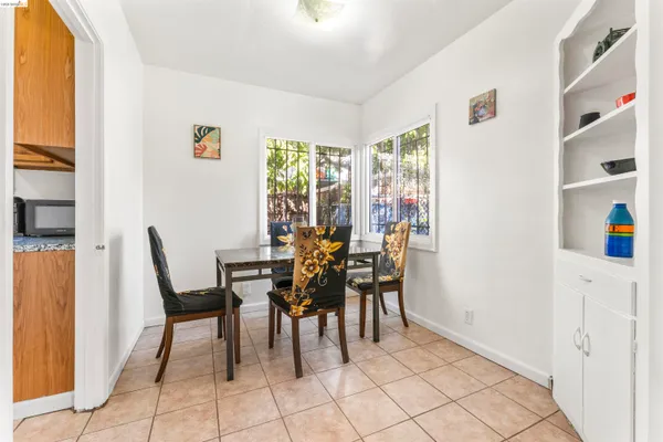 a view of a dining room with furniture and a window