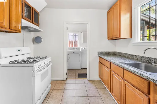 a kitchen with stainless steel appliances granite countertop a stove and a sink