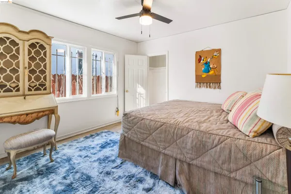 a bedroom with a bed and a couch